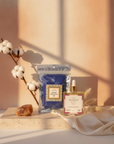 Cloud Nine Glow Bundle styled with a cotton branch, pink salt and ivory silk in warm window light
