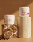Soft Skin Set in Expresso – Body Scrub and Body Butter on marble pedestals with coffee beans