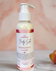 Body silk lotion bottle labeled 'Pineapple Peach' on a pink surface with a blurred background