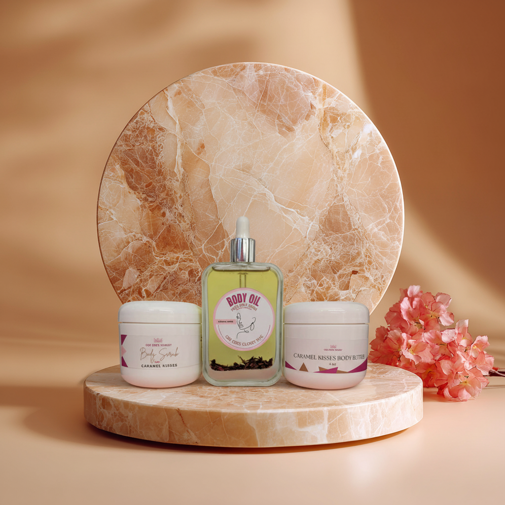 Caramel Kisses body scrub, dry body oil and body butter arranged together on a marble pedestal