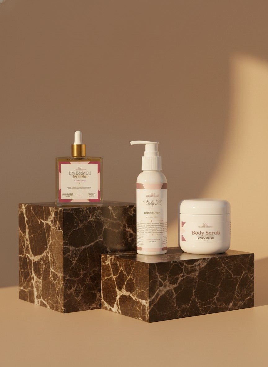 Unscented dry body oil, Unscented Body Silk and unscented body scrub on dark marble blocks in warm afternoon light