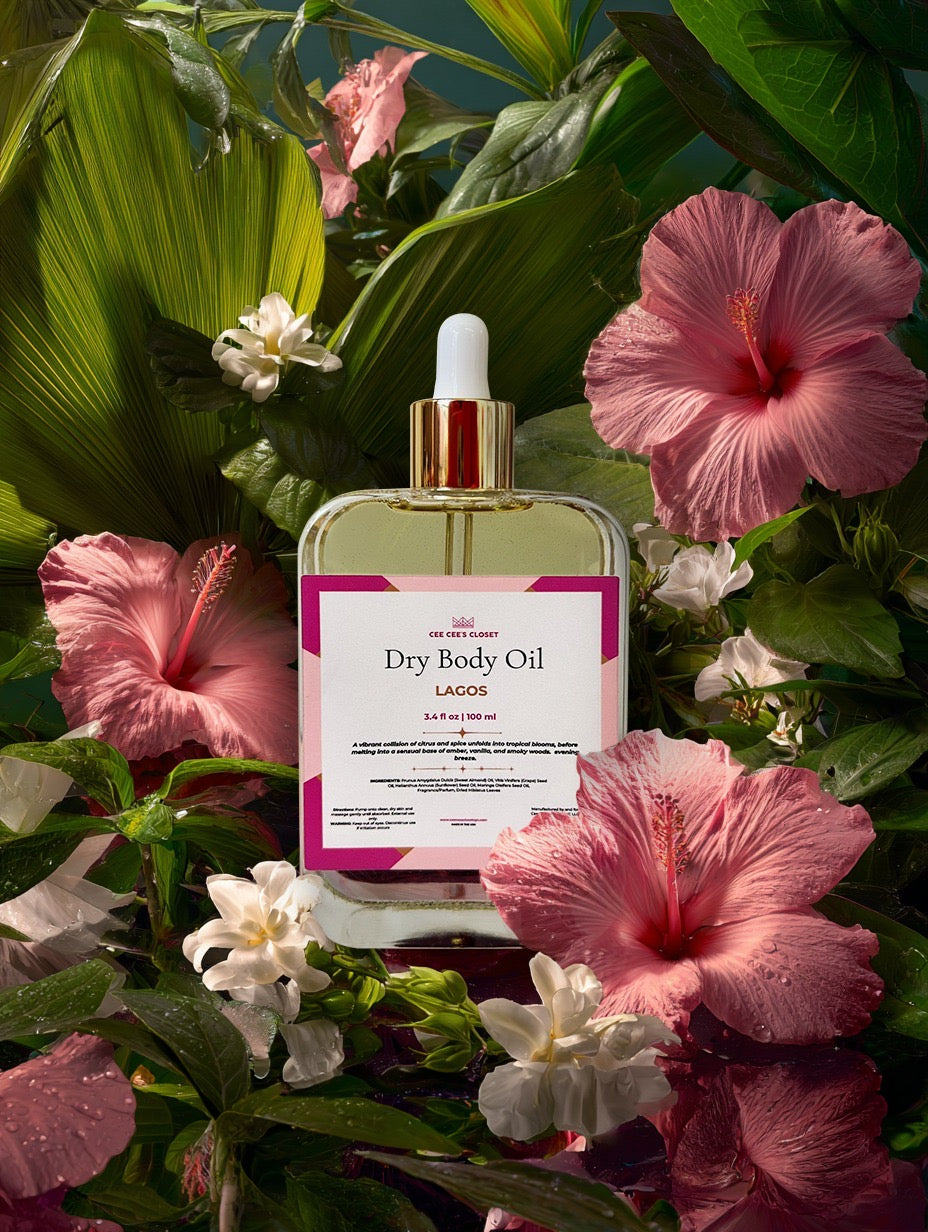 Lagos Dry Body Oil among pink hibiscus — retiring September 30