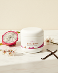 Dragonfruit Vanilla Whipped Body Butter on marble with dragonfruit, blossoms and crossed vanilla pods