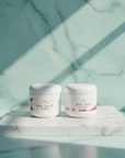 Soft Skin Set in Seychelles – Body Scrub and Body Butter on a marble plinth in soft window light